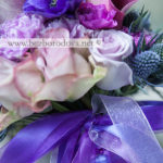 Яркий фиолетовый букет невесты из анемонов, сиреневых роз с винными каллами и синим эрингиумом